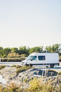 Small white transit van in the UK with a scenic background.